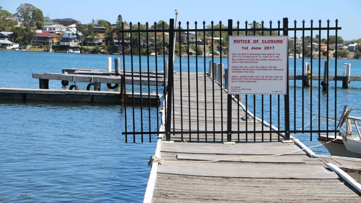 WONKY WAY: The notice of closure warning locals off the main arm of the jetty behind Wangi Wangi RSL Club. It's one of the jetties slated for work. Picture: David Stewart