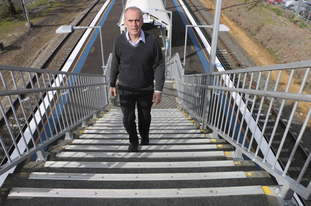 RELIEF COMING: MP Greg Piper takes on the Wyee Station steps in 2014. Picture: Jamieson Murphy