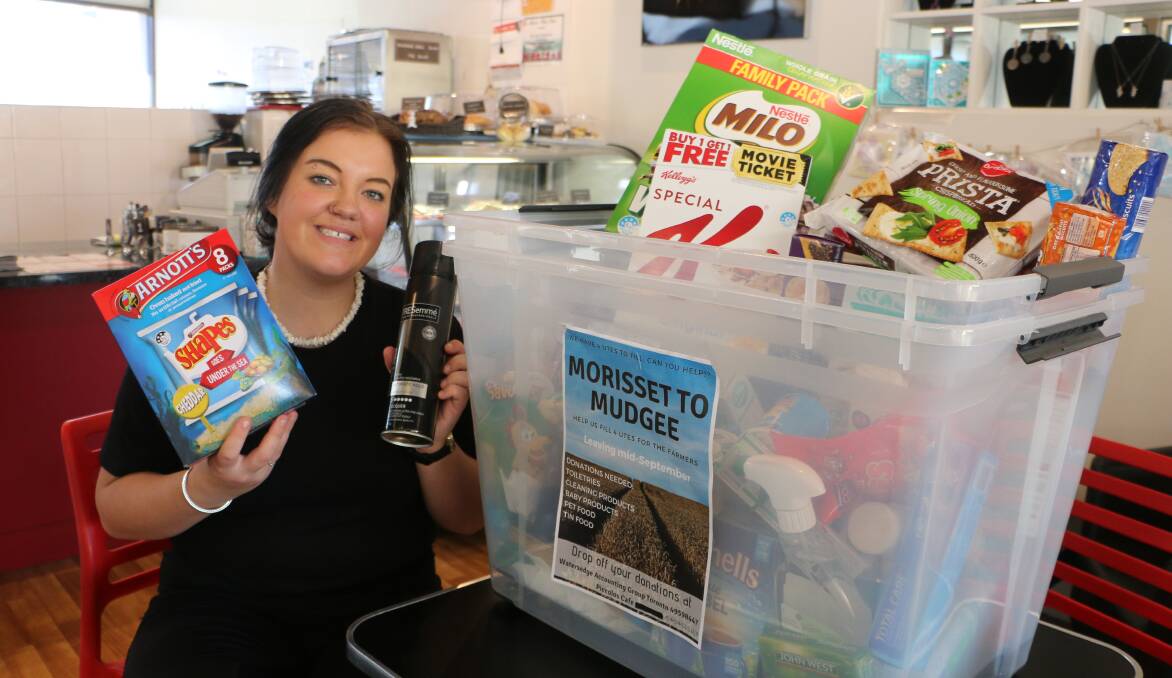 GREAT RESPONSE: Barista Jordan Fitzpatrick with a sample of the items left by customers in the cafe's donation tubs. Picture: David Stewart