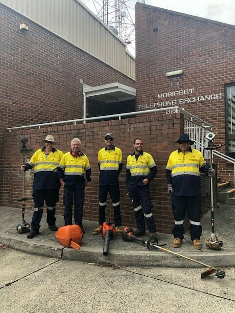 SAFETY: Participants from the House With No Steps take a break from their work at Telstra's Morisset Telephone Exchange. Picture: Supplied