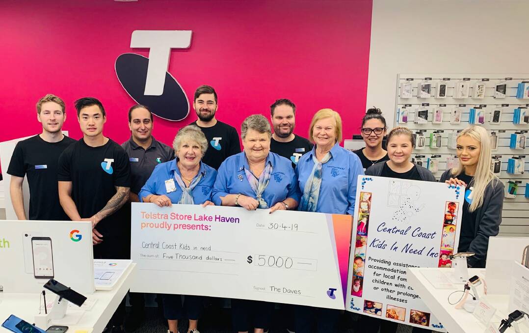 DONATION: Telstra Store Lake Haven staff with the $5000 cheque presented to Central Coast Kids In Need this week after a community vote. Picture: Supplied