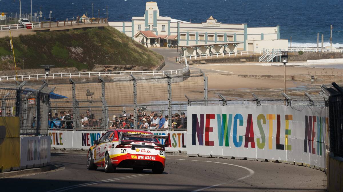 GETTING THERE: Scott McLaughlin powers past Newcastle Beach in last year's Newcastle 500 V8 Supercars race. Picture: Max Mason-Hubers 