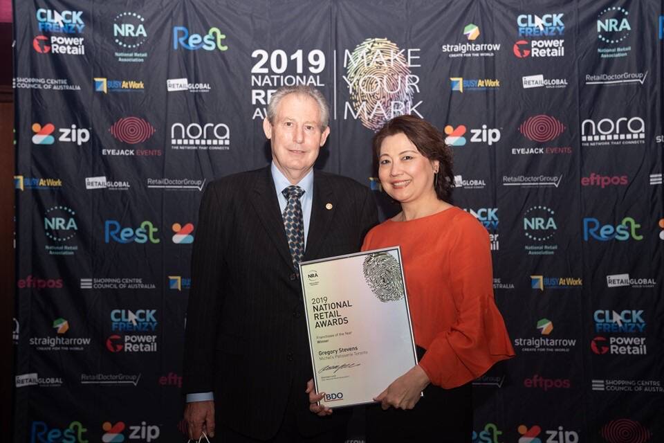 MORE SUCCESS: Greg Stevens and Annie Li, of Michel's Patisserie, in Toronto, receive the NRA Franchisee of the Year award in Sydney. Picture: Supplied