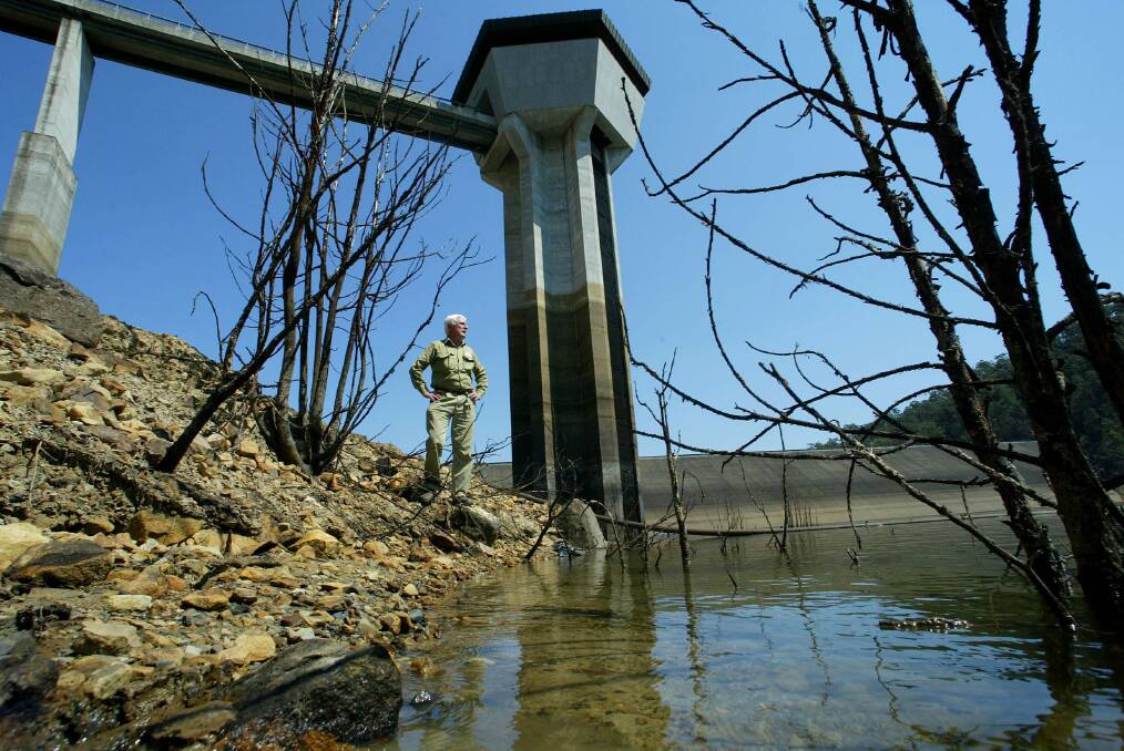 WATER SUPPLY: This picture, taken in October, 2004, shows Mangrove Creek Dam operator, John Webber, standing in an area that would have been 15 meters under water in 1990. Today, the dam is back at 61 per cent of capacity. Picture: Robert Pearce.