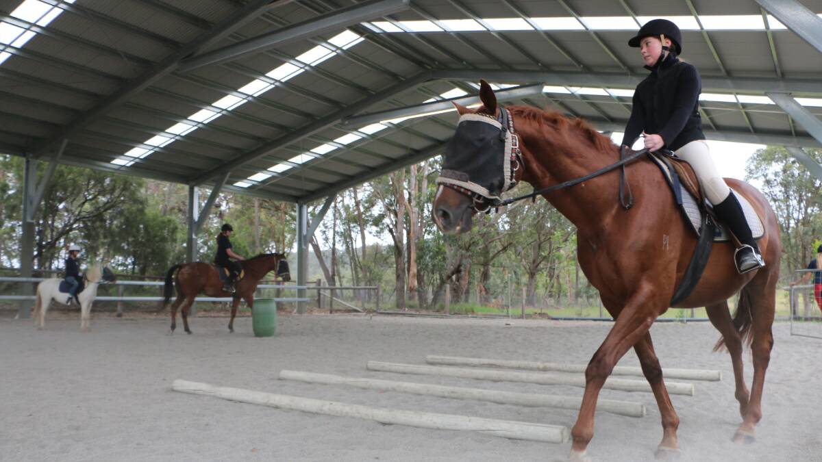 Margrete Erling of Yara Balba Stables puts her young charges through their paces in the new covered horse training arena at the Mandalong property.