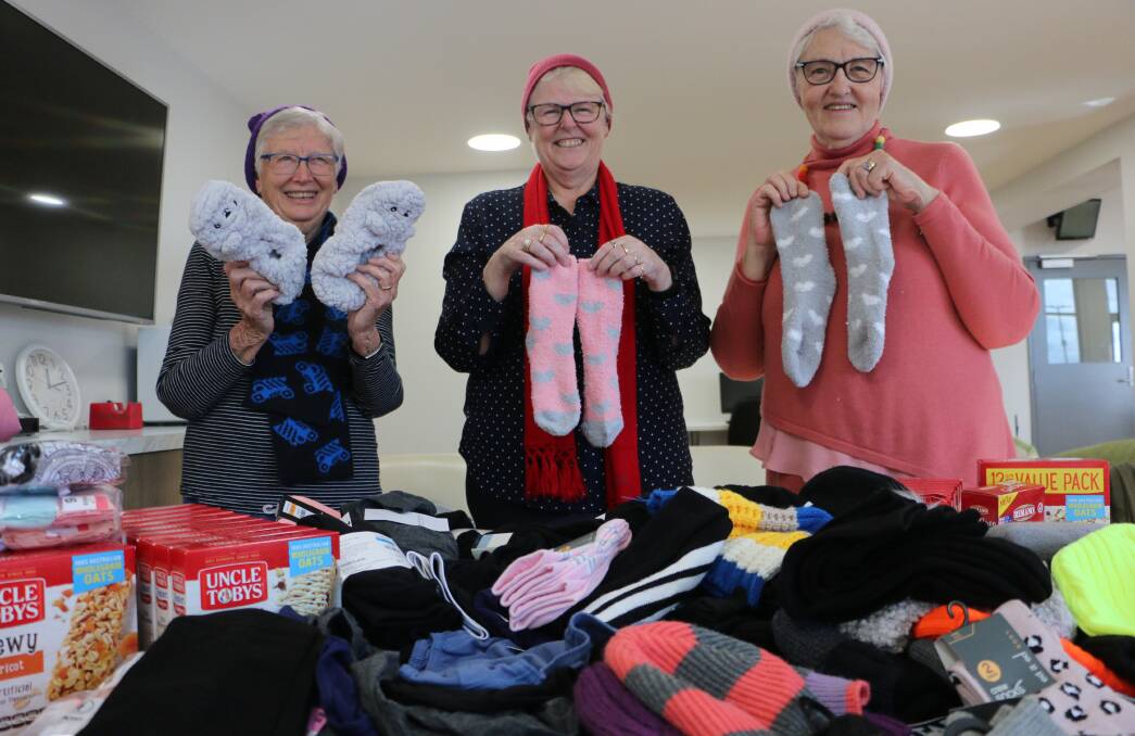 WINTER WARMERS: Leanne Bashford, centre, with Barabara Bond, left, and Elza Crawford and a sample of the items donated by hospital staff. Picture: David Stewart