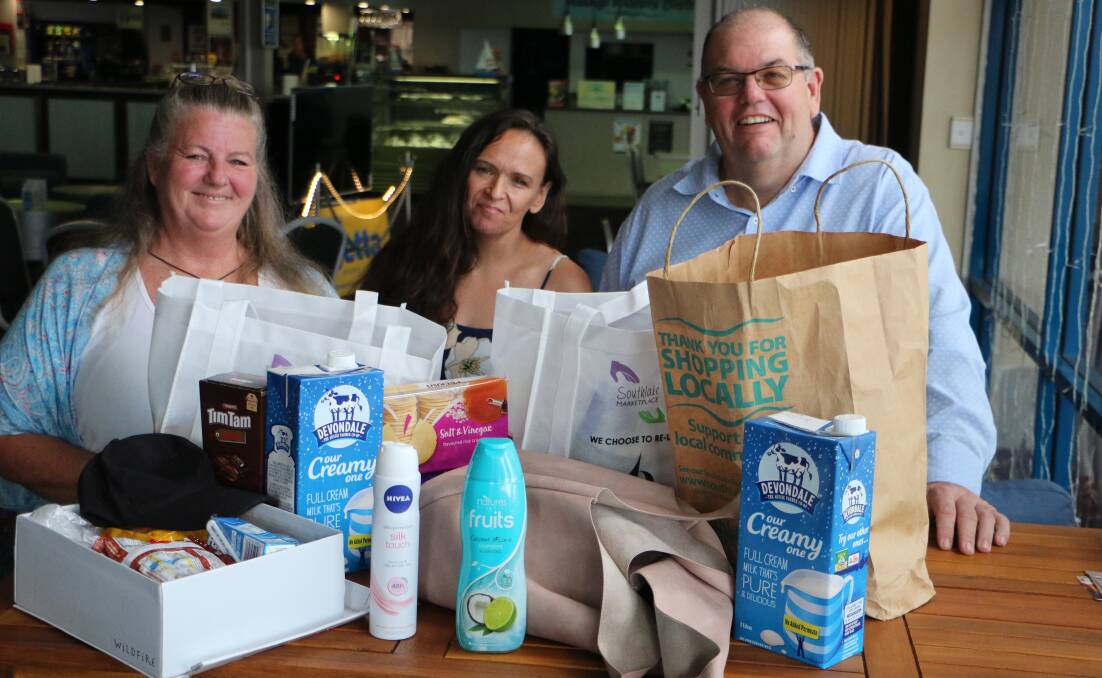 RELIEF PACKAGES: From left, Vicky Carr, Christine Mastello and Wayne Izzard with a sample of the items on offer at the club on Friday mornings. Picture: David Stewart