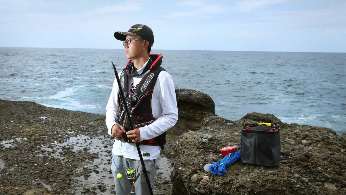 SAFETY FIRST: Rock fisherman, Eric Xue, from Eastwood in Sydney, does the right thing and wears a life vest when he fishes at Snapper Point, in Munmorah State Conservation Area. Picture: Marina Neal