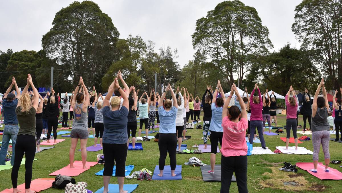 BEND, STRETCH: Participants in the free mass yoga class at last year's festival. Even more people are expected to get involved this year. No registration is required. Simply turn up on the day. Picture: Supplied.