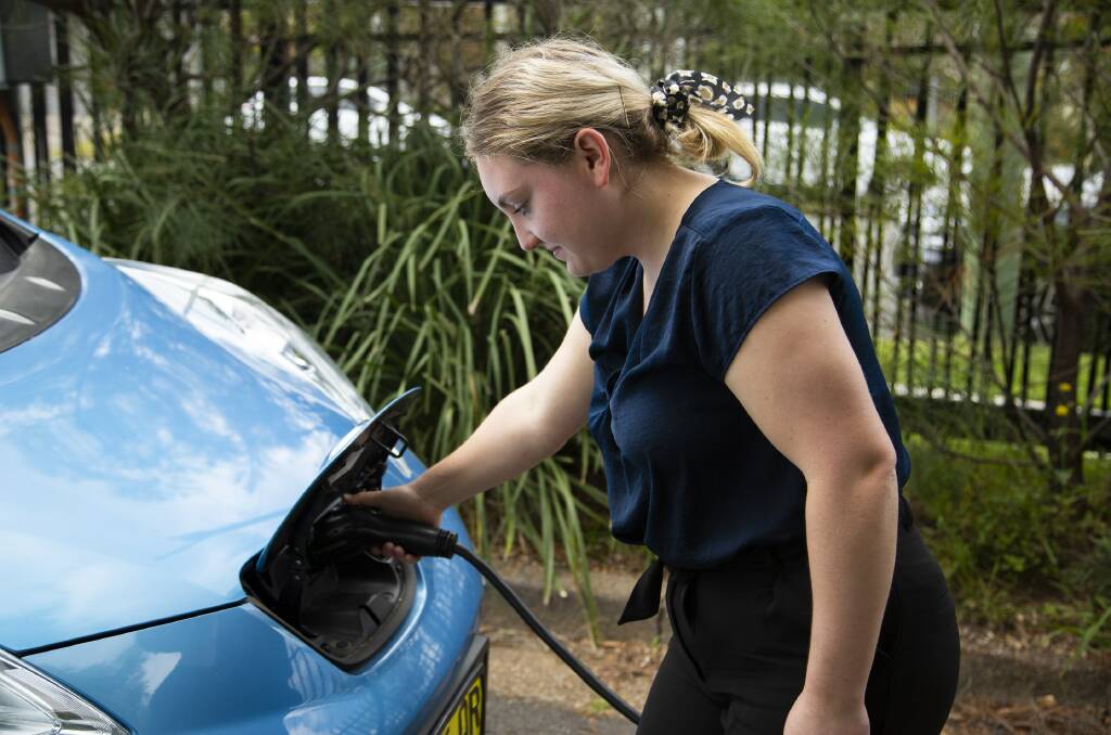 DRIVING CHANGE: A motorist charges an electric vehicle at Speers Point. The council is proposing a network of EV charging stations across the city. Picture: Supplied