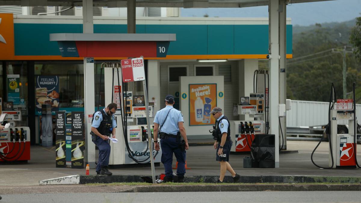 CRIME SCENE: Police at the petrol station where a man allegedly stabbed two officers before being apprehended with the help of men serving a community service order. Picture: Jonathan Carroll