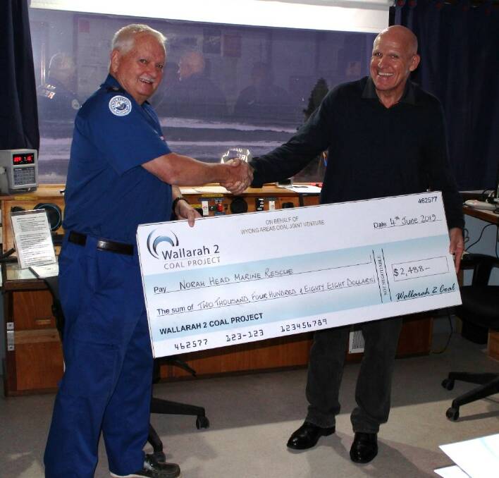 ALL YOURS: Wyong Coal general manager Peter Allonby, right, with William Hignett, unit commander of Norah Head Marine Rescue. Picture: Supplied 