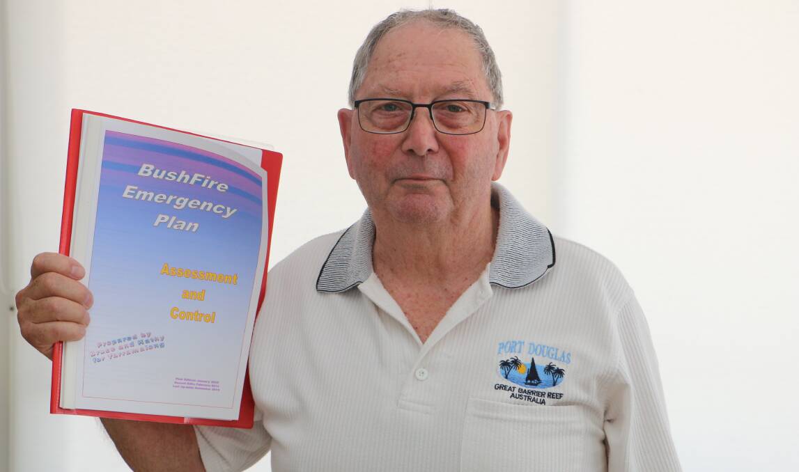 HARD COPY: Bruce Talbot with the documented plan that he and wife Kathy will implement if fire threatens their Bonnells Bay neighbourhood. Go to the RFS website to formulate your plan. Picture: David Stewart