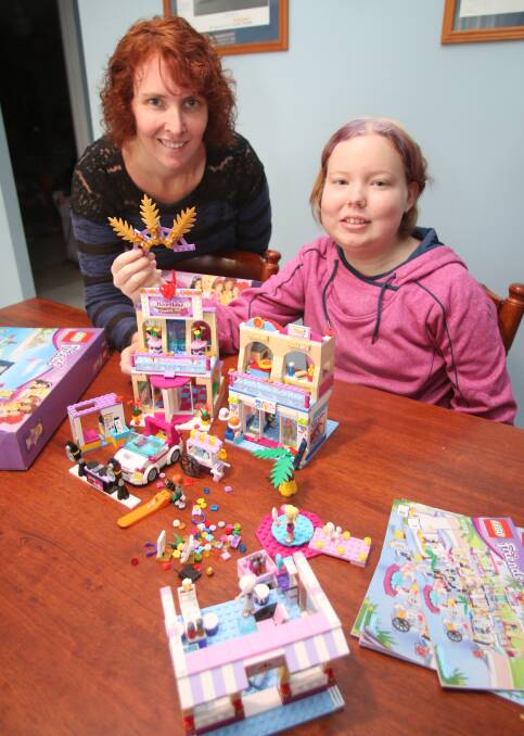 FUN DISTRACTION: Kirsten and Jacinta Gomez at their Morisset Park home. Building with Lego had become Jacinta's escape, her mum said. Picture: David Stewart