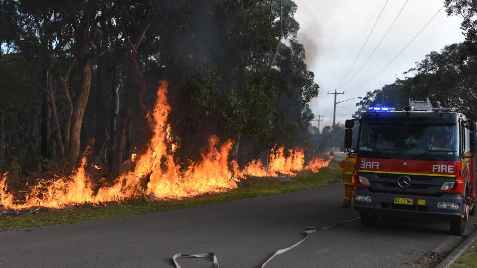 Firefighters conducting a hazard reduction burn at Wyee to help stop the advancing grass fire that started in Doyalson earlier this month. A hazard reduction burn is planned for Cooranbong on Sunday. Picture: Chris VanderSchaaf.