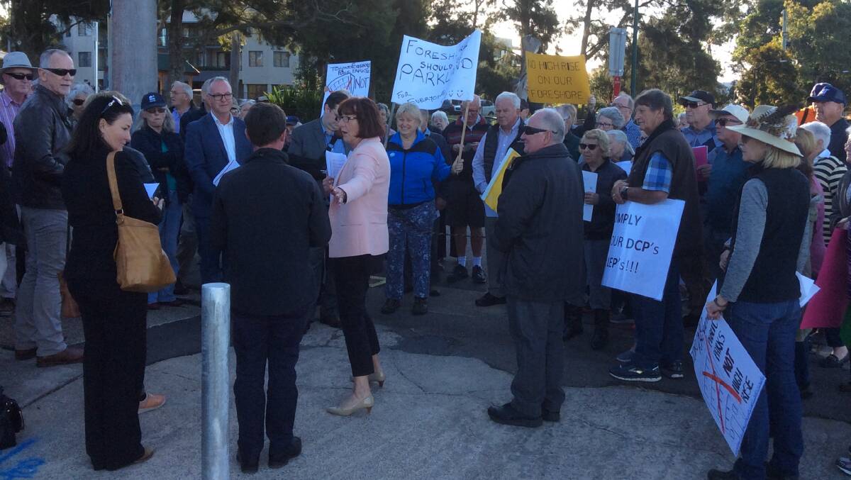 OPPONENTS: Mayor Kay Fraser and councillors were met by locals waving placards when they inspected the Brighton Avenue property on Thursday. Councillors approved the DA for the site on Monday night. Picture: Supplied.
