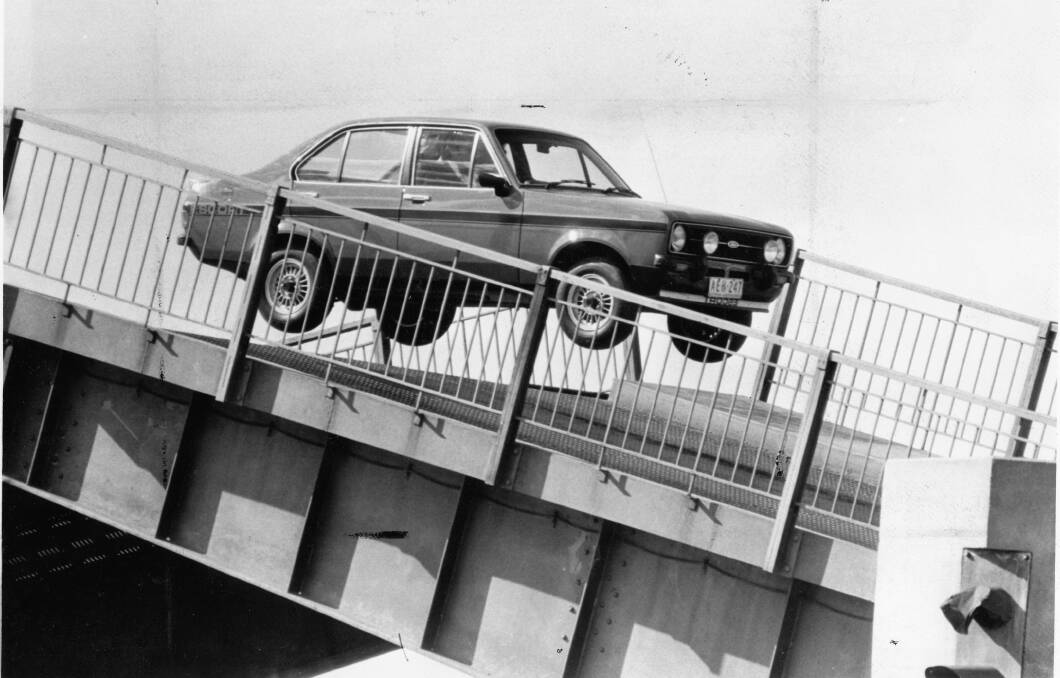 UP AND OVER: Former racing car driver Colin Bond pilots a Ford Escort over the open Swansea Bridge in 1978 during filming for a TV commercial. One lane of the bridge will be closed to motorists at night next week.