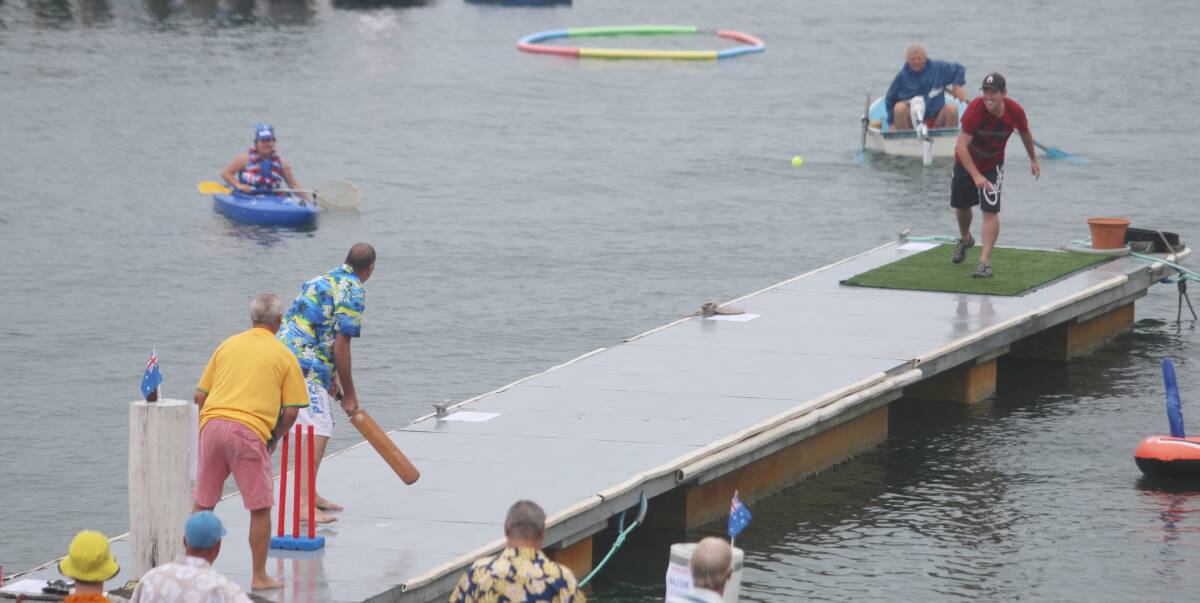 FLOATING PITCH: Action from last year's inaugural pontoon cricket match played in drizzle at Royal Motor Yacht Club, Toronto. Organisers are hoping for clear skies for this year's game on Australia Day. Picture: Jamieson Murphy