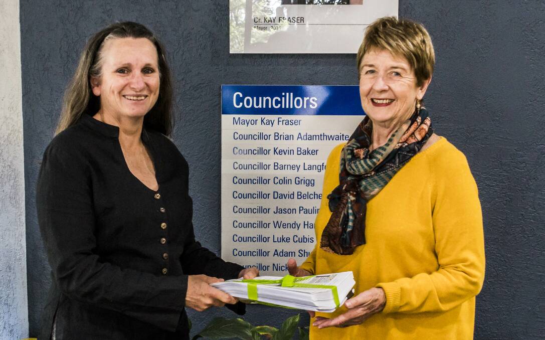 HANDOVER: Suzanne Pritchard, left, of Toronto Foreshore Protection Group presents Cr Wendy Harrison with the petition before Monday night's council meeting. Picture: Supplied