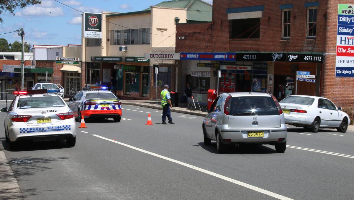 LINE OF SIGHT: A police operation on Dora Street, Morisset, close to where the RMS plans to install traffic lights to replace the painted pedestrian crossing. Picture: David Stewart