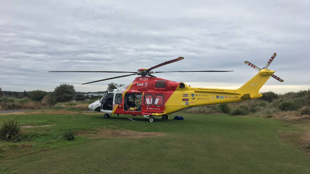 ARRIVAL: The Westpac Lifesaver Rescue Helicopter lands at Magenta Shores this morning to transport motorists involved in the accident on Central Coast Highway to hospital. Picture: Supplied