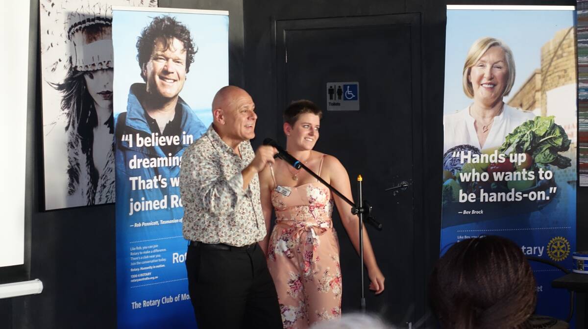 UPLIFTING STORY: Morisset Rotary Club president Mick Payze introduces club member and medical student Eleni Comino to the dinner guests. Picture: Supplied
