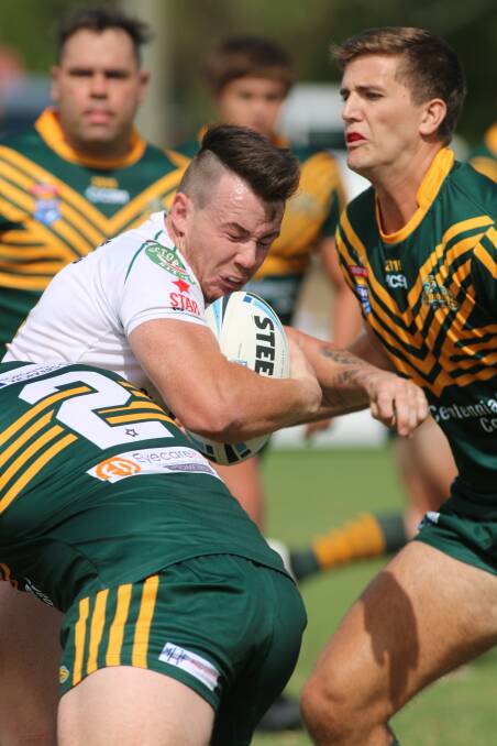 CONTACT: Wyong's Luke Dolbel meets some stiff Macquarie Scorpion defence in the match at Lyall Peacock Field on Saturday. The Roos scored a 32-16 win. Picture: David Stewart