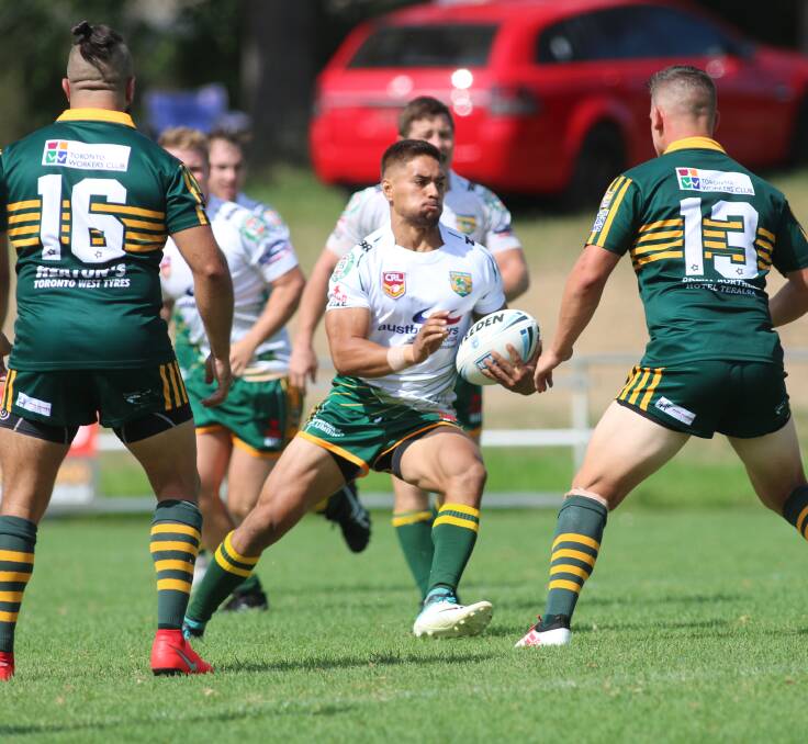 SURROUNDED: Wyong's Ethan Tetevano tries some footwork as he approaches the Macquarie defensive line. Picture: David Stewart