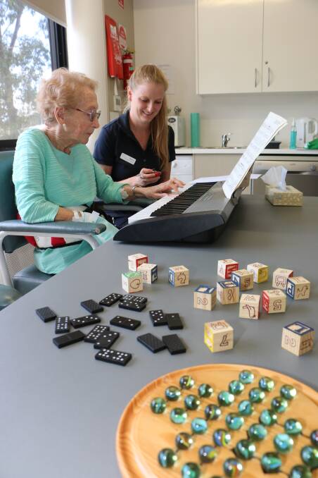 RECOVERING: Melanie Glapa times Janice McCarty's work on the keyboard. Also on the table are some of the items used by clinic participants in exercises to boost their fine motor skills. Picture: David Stewart