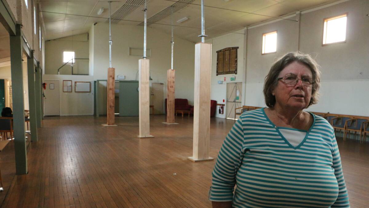 HOLD UP: Four beams support the sagging ceiling in Morisset Memorial Hall. Val Badham says council is responsible for the damage. Picture: David Stewart