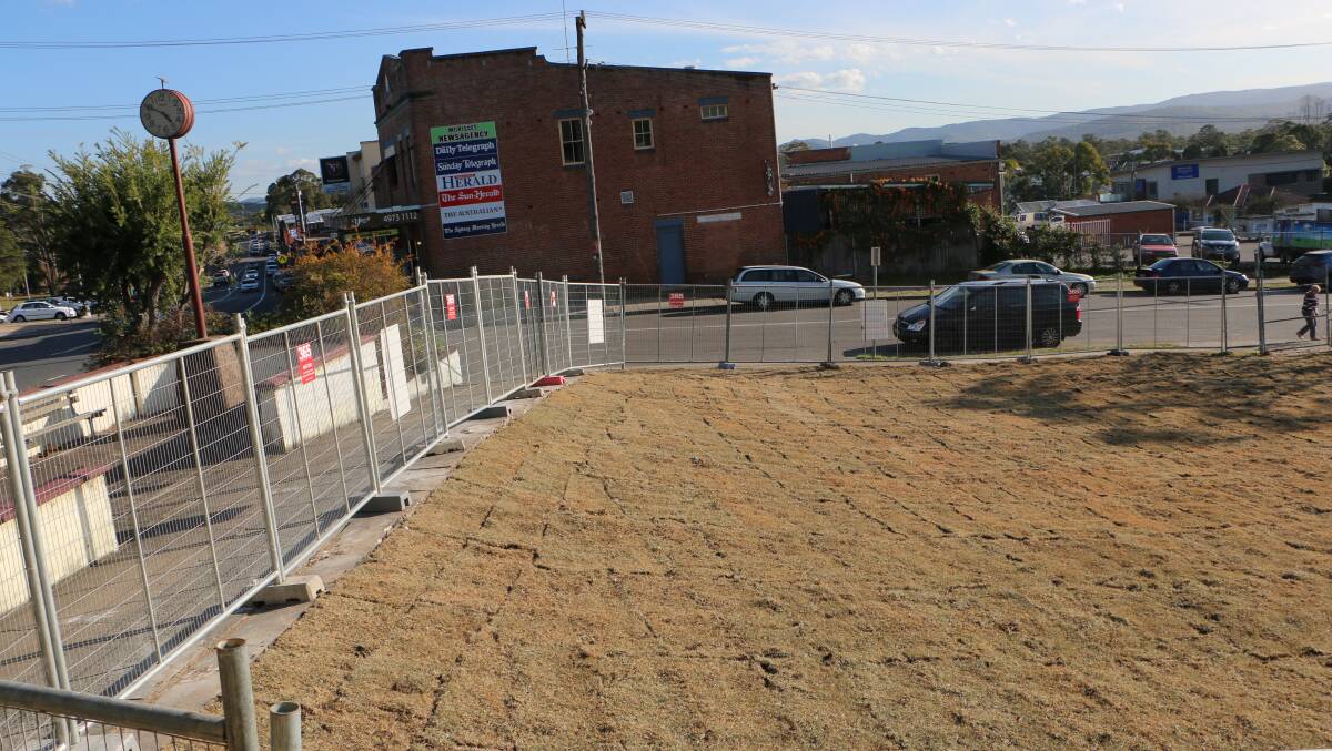 MAKING WAY: The old post office has been cleared. Temporary fencing will remain in place while new turf is watered in. The site will form part of a new community facility the council has planned for the CBD. Picture: David Stewart