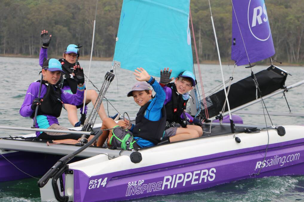 AT THE HELM: Joel Beashel (in the blue top) skippers a catamaran for participants in the SailGP Inspire Learning Camp at Point Wolstoncroft last month. Picture: David Stewart 