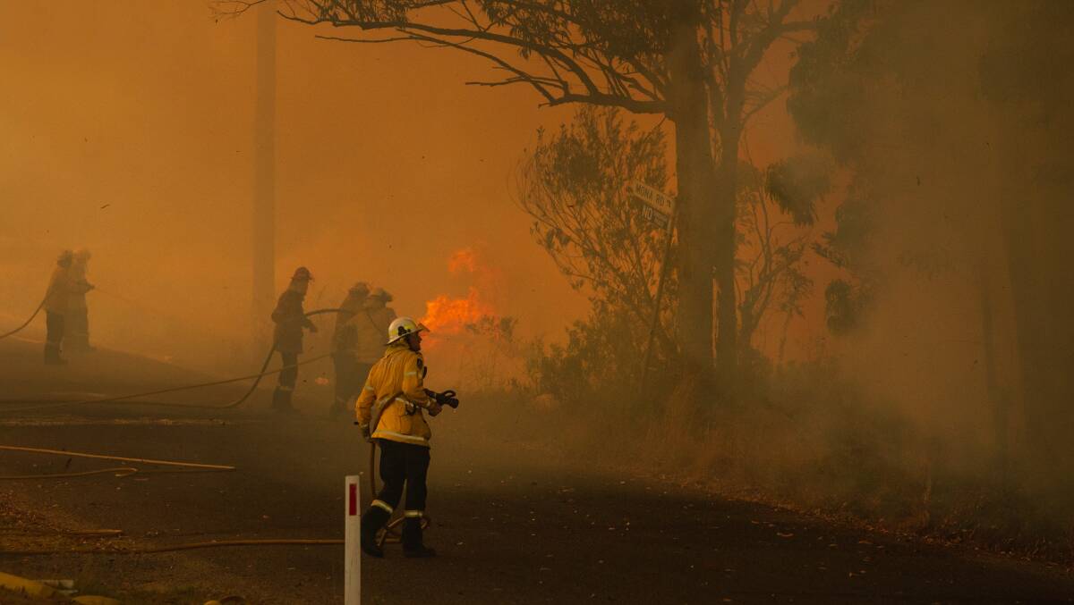 RFS crews at work on Arizona Road, Charmhaven. What can Australia do to prevent a repeat of this summer's bushfires? A parliamentary inquiry is open to community submissions. Picture: Marina Neil.