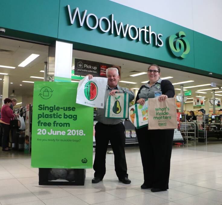 NEW HABIT: Woolworths Morisset's Paul Evans and Deanne Ashton with a sample of the reusable bags available for shoppers to buy. Picture: David Stewart
