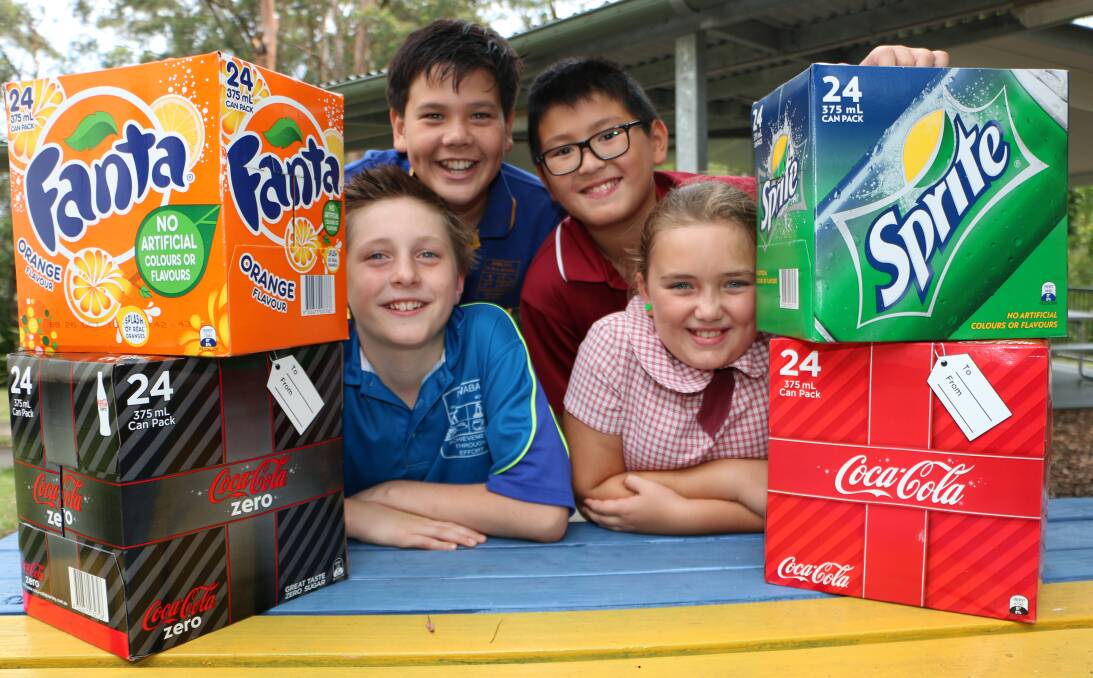 SPECIAL DELIVERY: Awaba Public School captains Luke Sneddon, top, and Jackson Bunn, front, with Speers Point students Raphael Keo and Alaska Hitchcock and the donated drinks. Picture: David Stewart