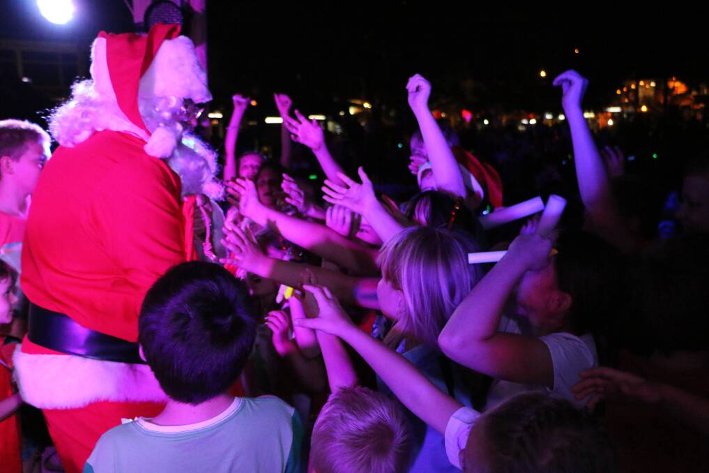 TRADITION: Santa is pictured greeting kids at the Carols by the Lake evening in Toronto in 2014. It's a fun night out for families. Picture: Jamieson Murphy