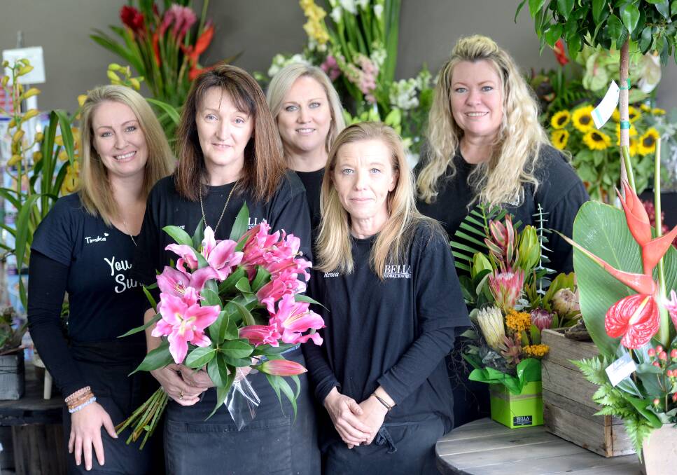 BLOOMING SUCCESS: Carmen Wells (holding flowers) with some of the team from Bella Floral Boutique, which is a finalist for two statewide awards. Picture: Supplied