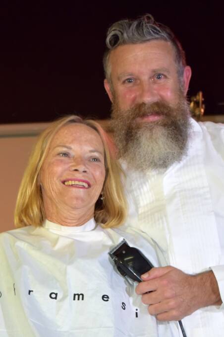 Liz Wright about to get her head shaved by Steve Hannon, of Wangi Barber Shop and Beardery, as a fundraiser for Ovarian Cancer Australia in 2018. Picture: Supplied