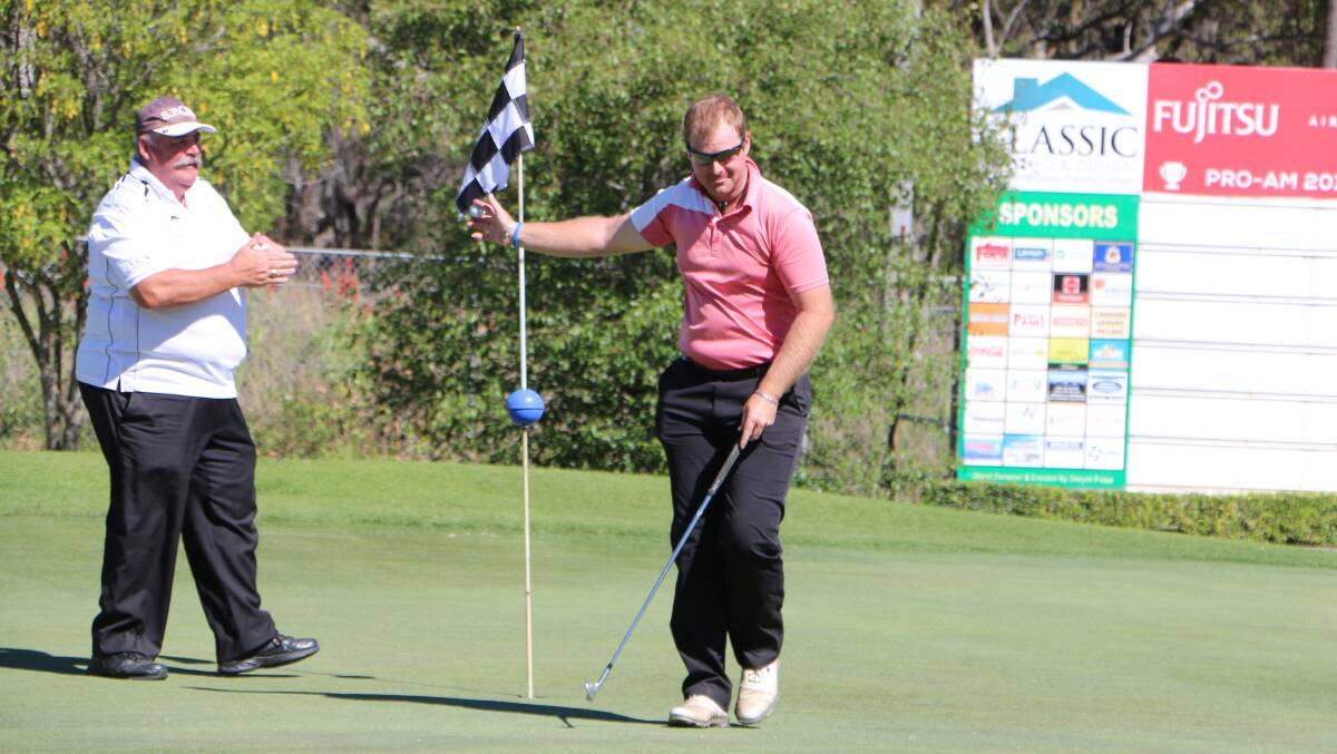 UNBEATABLE: Kurri Kurri's Chris Ford extracts his ball from the cup after landing a hole-in-one to win the pros' shoot-out last year. The nearest-the-pin challenge will be held on Friday afternoon. Picture: David Stewart