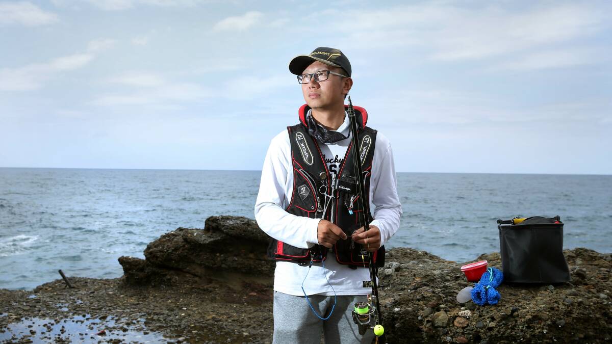 SAFETY FIRST: Eric Xue, of Sydney, wears a life vest when he fishes at Snapper Point. Picture: Marina Neil 