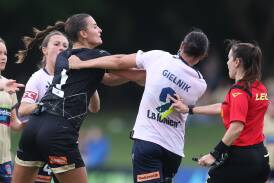 Newcastle Jets goalkeeper Izzy Nino and Melbourne Victory's Emily Gielnik grapple at No.2 Sportsground on Saturday. Picture Getty