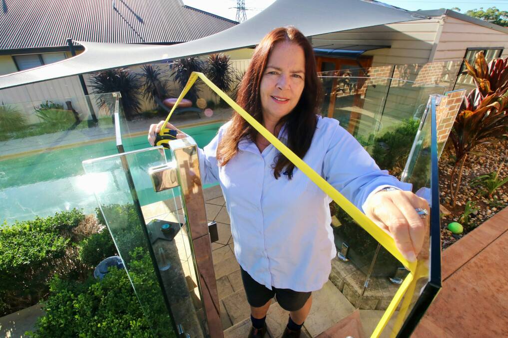 MAKING THE GRADE: Lake Macquarie City Council compliance officer Sandra Harman inspects a pool gate. 