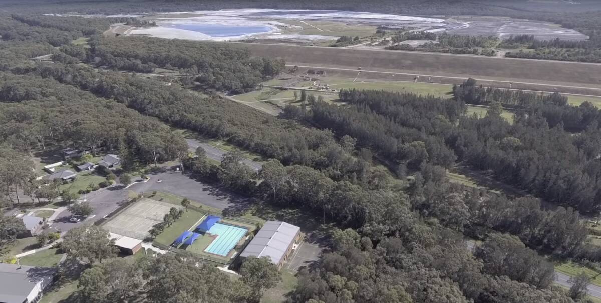 AT RISK: Myuna Bay Sport and Recreation Centre with Eraring power station ash dam in the background. Picture: YouTube