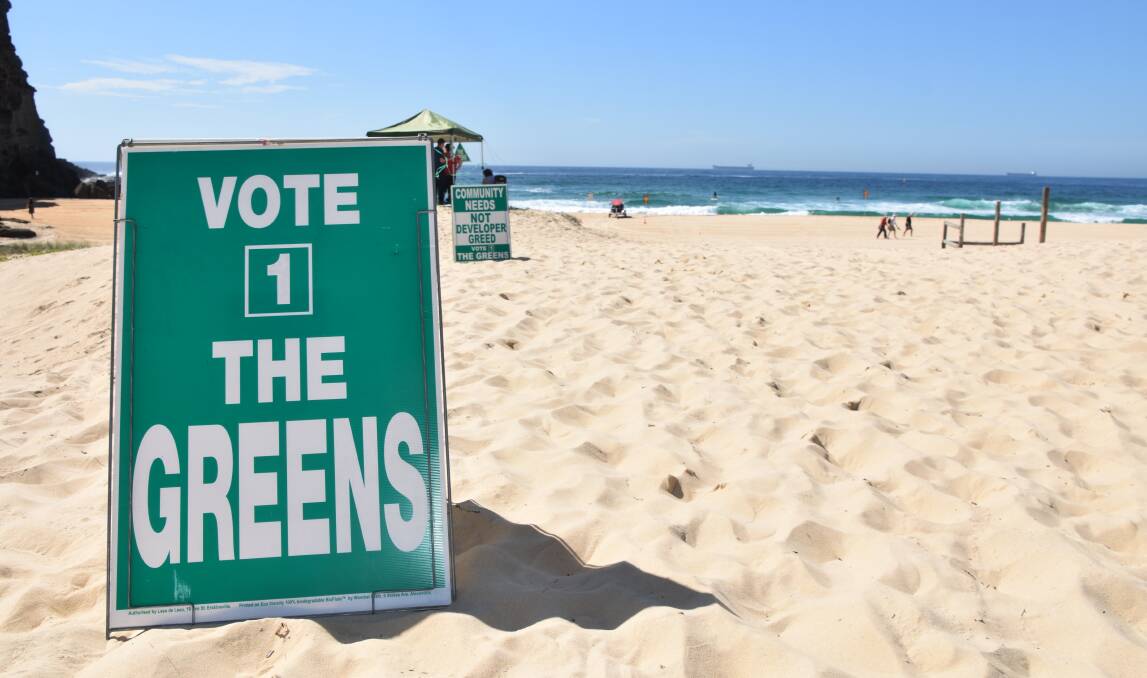THIS WAY: Signs on Redhead beach for the launch. Picture: Max McKinney