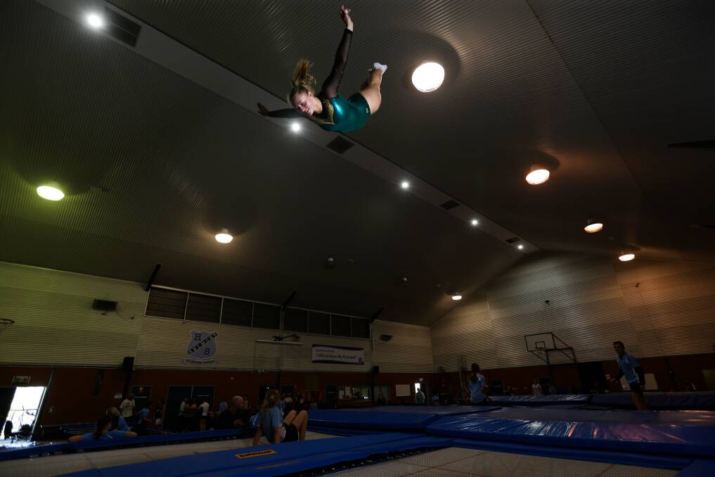 EXTENSION: Jessica Pickering performs on a trampoline at Belmont High School. She trains at the school with national coach Brett Austine. Picture: Jonathan Carroll