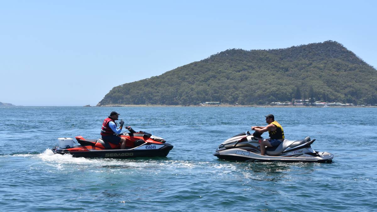 CHECKS: A personal watercraft operator being spoken to at Shoal Bay. 