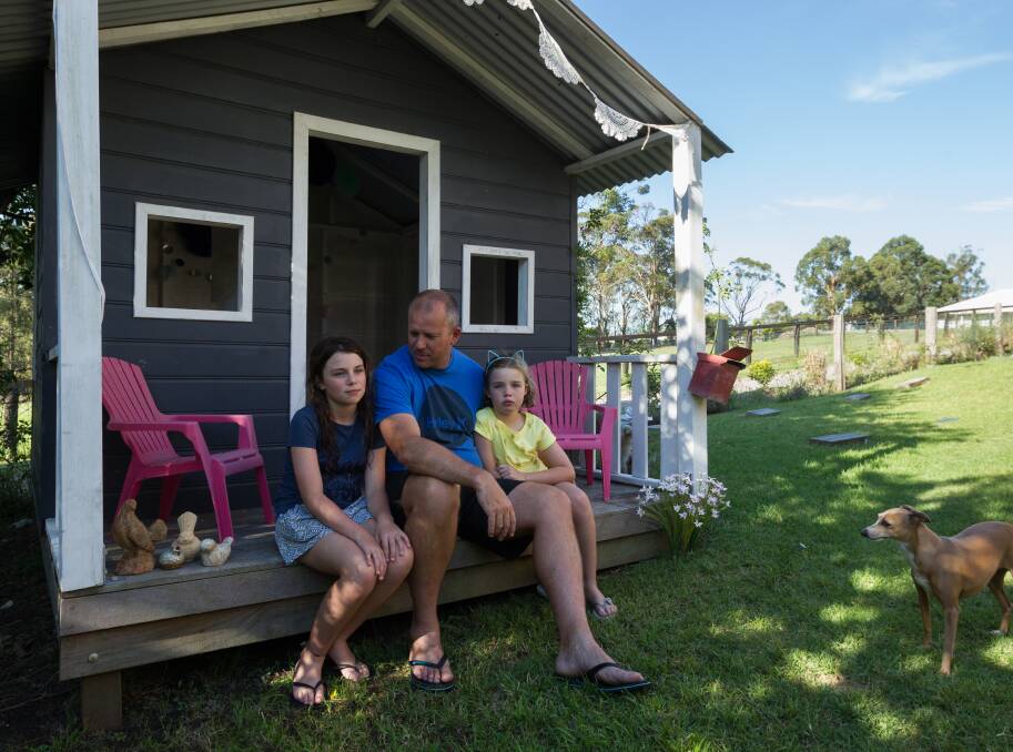 Not happy: Garth Hawgood and daughters Olivia and Bethany at the Wakefield home that is close to a proposed $77 million raceway resort proposal. Picture: Max Mason Hubers. 