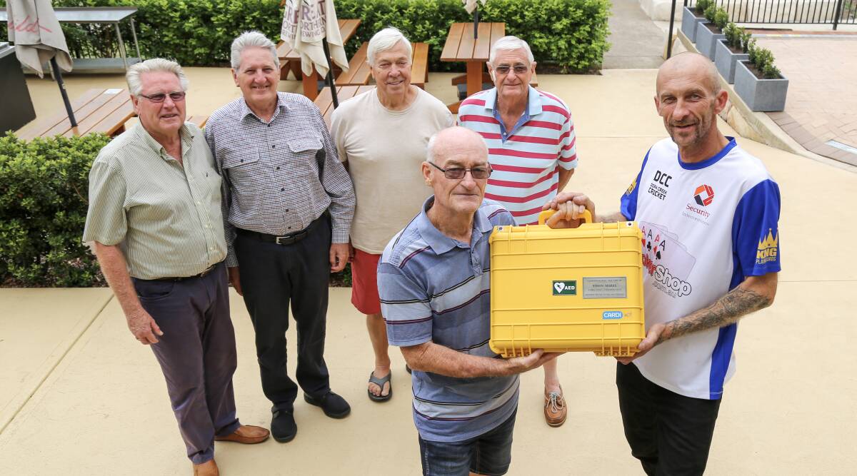 LIFE-SAVING: Bob Sainsbury, Russell Ware, Cenny Wagemaker, Bob Woods, front, Bob Marks and Karl Zalewski with a defibrillator donated to the Dora Creek Workers Cricket Club's D2-grade team in honour of Simon Marks. Picture: Ellie-Marie Watts