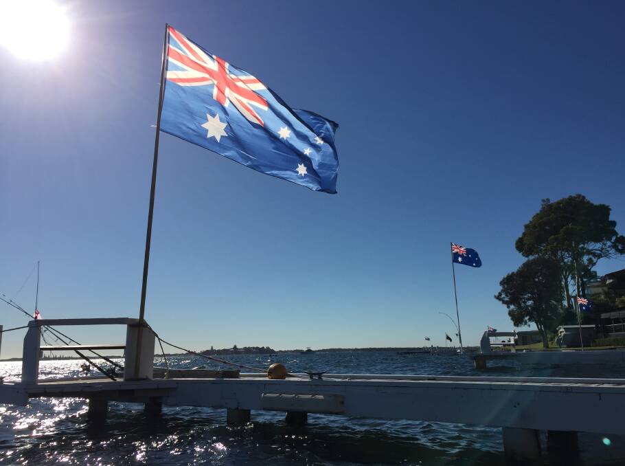 Flags along the foreshore in Lake Macquarie. Picture: Scott Bevan