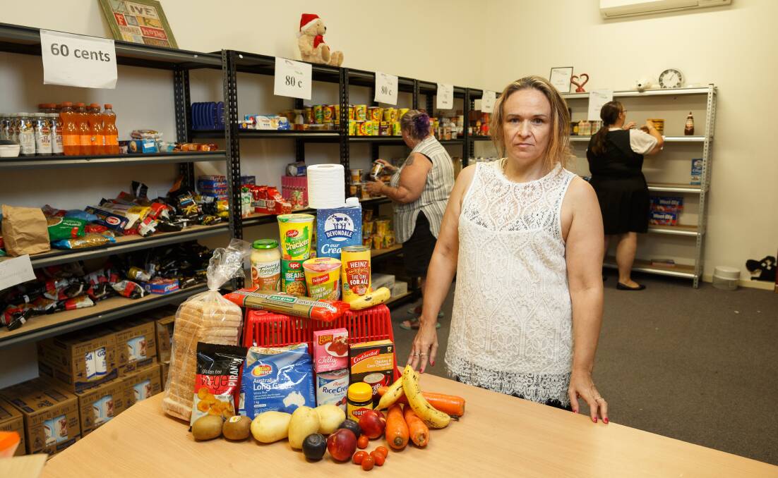 RESTRICTIONS: Southlake Marketplace founder Christine Mastello with the contents of an "essential food pack" at the service's Cooranbong hub, with committee members Vicky Carr and Kerriann Dunn inspecting the shelves. Picture: Max Mason-Hubers 
